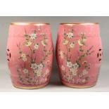 A PAIR OF CHINESE PINK POTTERY BARREL SEATS painted with birds and flowers. 17ins high.