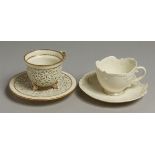 A ROYAL WORCESTER EMPRESS SHAPED TEACUP AND SAUCER with reticulated border moulded with 'C' scrolls.