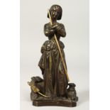 A GOOD SMALL BRONZE OF A SHEPHERDESS, a dog at her side. 7ins high.