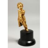 A GOOD SMALL 19TH CENTURY GILT BRONZE CUPID on a circular plinth. 12cm high.