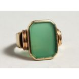 A GOLD ONYX SIGNET RING