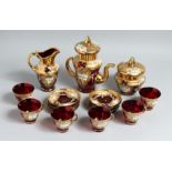 A CONTINENTAL GLASS GILT AND ENAMEL PAINTED TEA SET comprising tea pot, sugar bowl, milk jug and six