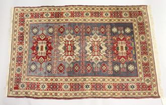 A PERSIAN RUG, cream ground with four large central medallions. 6ft 8ins x 4ft 5ins.