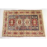 A PERSIAN RUG, cream ground with four large central medallions. 6ft 8ins x 4ft 5ins.