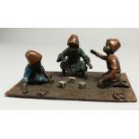 A VIENNA BRONZE GROUP, THREE BOYS PLAYING DICE. 19cm wide.