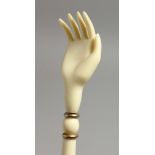 A 19TH CENTURY EUROPEAN IVORY CARVED BACK SCRATCHER, one end with a hand, the other with bobbin type
