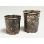 TWO SILVER THIMBLE-SHAPED CUPS engraved "just a thimble full".