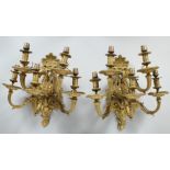 A GOOD PAIR OF ORMOLU FIVE LIGHT WALL LIGHT APPLIQUES with two ties of scrolling light branches