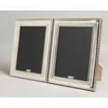 A LARGE PAIR OF SILVER PHOTOGRAPH FRAMES 22cm x 17cm