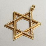 A GOLD AND DIAMOND SET STAR OF DAVID PENDANT.