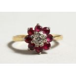 AN 18CT GOLD RUBY AND DIAMOND CLUSTER RING.