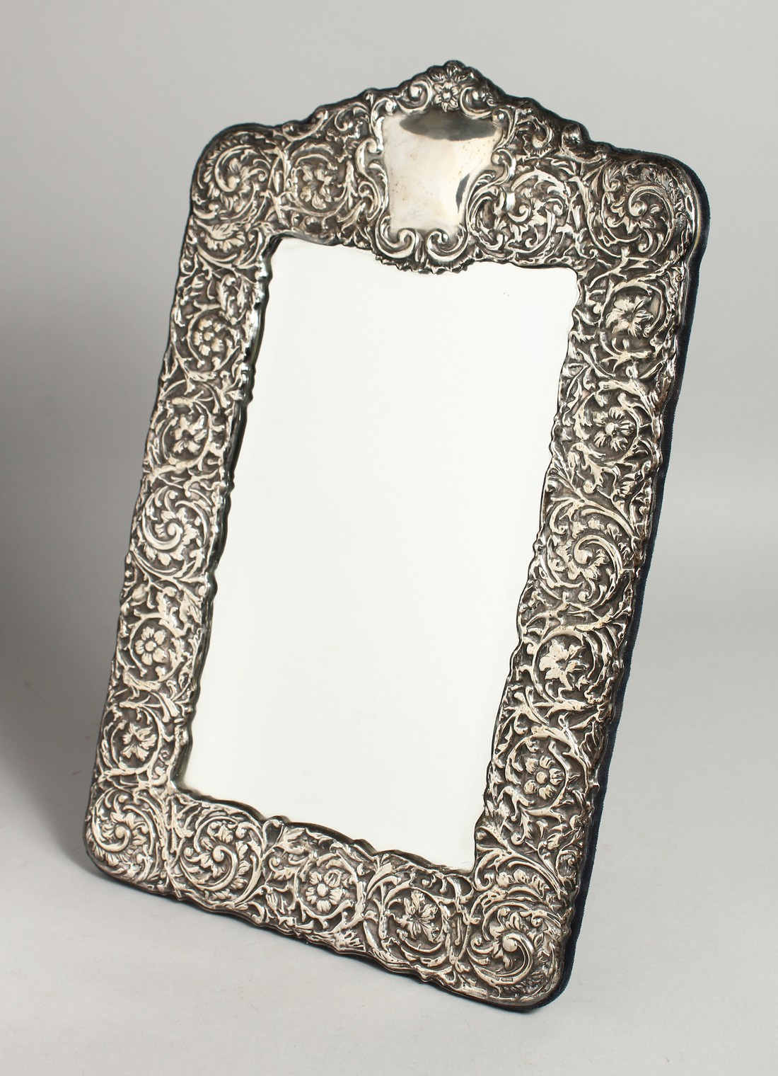A GOOD REPOUSSE UPRIGHT MIRROR. 16.5ins x 10ins.