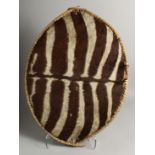 A ZEBRA HIDE ZULU SHIELD 26ins x 18ins.