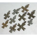 TEN SMALL ROMAN IRON CROSSES, 3/4ins.