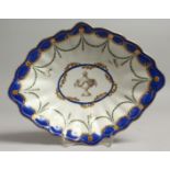 AN 18TH CENTURY CHELSEA DERBY FLUTED LOZENGE SHAPED DISH painted with a central urn with surrounding