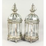 A PAIR OF CIRCULAR SILVERED METAL LANTERNS. 24ins high.