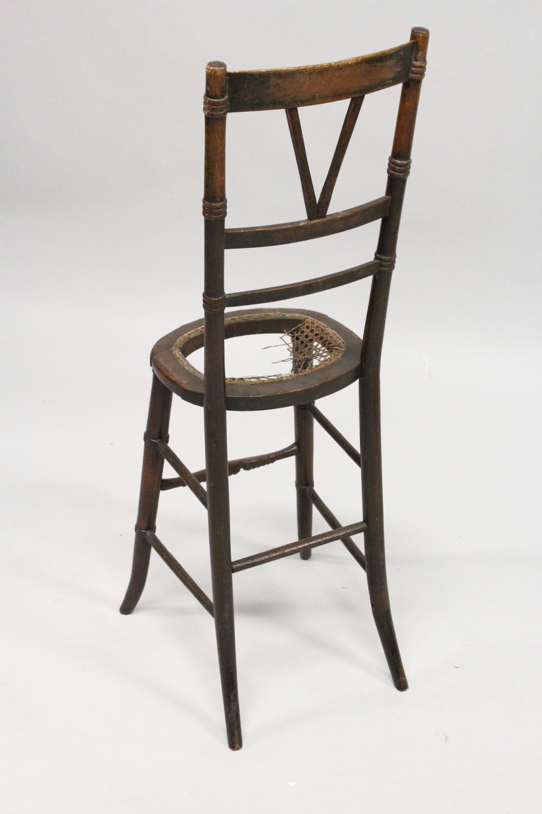 A 19TH CENTURY BEECH FRAMED AND CANE WORK SEATED CORRECTION CHAIR (SEAT A. F.). 3ft 2ins high - Image 2 of 2