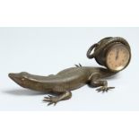 A GOOD BRONZE LIZARD holding a clock in its tail. 9.5ins long.