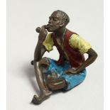A PAINTED BRONZE COLD CAST SEATED MAN SMOKING A PIPE, 5cm.