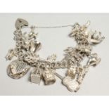 A GOOD SILVER CHARM BRACELET, 20 CHARMS 77grams.