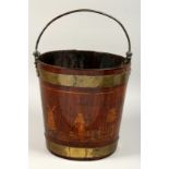 A 19TH CENTURY MAHOGANY AND BRASS BOUND BUCKET, with brass handle, the bucket inlaid with figures in