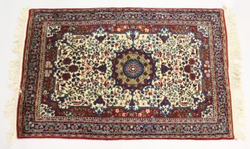 A PERSIAN RUG, cream ground with all over floral decoration. 5ft 6ins x 3ft 7ins
