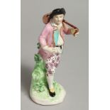 AN 18TH CENTURY DERBY FIGURE OF A VINTNER carrying a barrel over his shoulder.