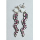 A PAIR OF RUBY AND MOTHER OF SNAKE PEARL EARRINGS.