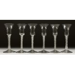 A SET OF SIX WINE GLASSES with inverted bell bowls and white opaque stems