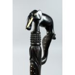 A CEYLONESE EBONY WALKING STICK with elephant handle 32ins long.