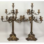 A VERY GOOD PAIR OF TEN LIGHT, BRONZE CLASSICAL CANDELABRA with column supports. scrolling arms,