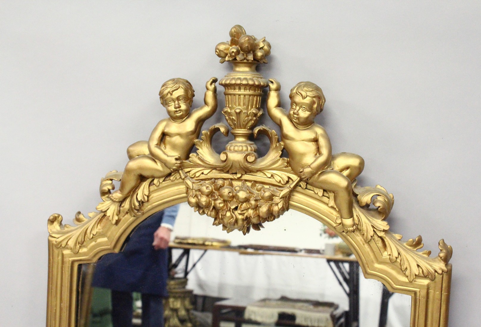 A 19TH CENTURY GILT FRAMED PIER MIRROR, with a shaped top, surmounted with a pair of cherubs holding - Image 2 of 3