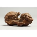 A JAPANESE CARVED WOOD NETSUKE OF TWO TURTLES Signed, 5.5cm long