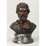 A GOOD CLASSICAL BRONZE BUST of a man. Signed, 7.5ins high, on a circular base.