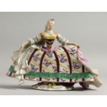 A GOOD CONTINENTAL PORCELAIN FIGURE OF A YOUNG LADY wearing a large dress, with flowers. 7.5ins