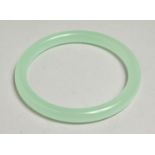 A GOOD ICY JADE BANGLE, 7cm diameter.