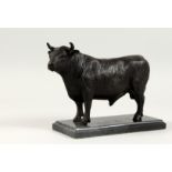A BRONZE STANDING BULL on a marble base. 9ins long.