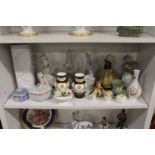 A shelf of decorative china to include Lladro and Rosenthal.