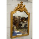 A 19th century gilt framed pier mirror with cherub and urn cresting.