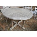 A circular teak garden table.