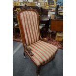 A Victorian walnut framed high-back upholstered bedroom chair.