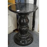 A heavy turned marble pedestal stand.