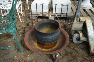 A cast iron cauldron, a fire pit and Welly boot holder.