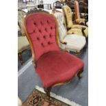 A Victorian carved walnut framed button upholstered nursing chair.