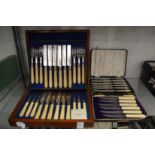 A mahogany cased twelve place fruit knife and fork set and two other sets of knives.