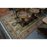 An eastern rug, cream ground with stylized decoration.