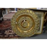 A good large, embossed brass circular charger.