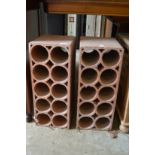 A pair of terracotta wine racks.