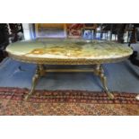 An onyx and brass oval coffee table.