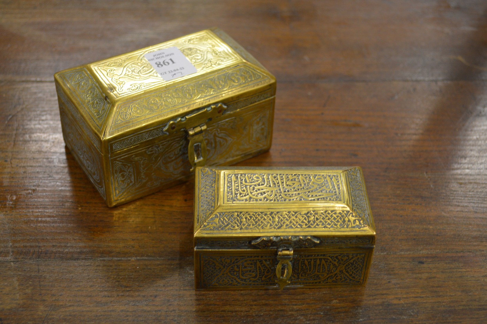 Two eastern engraved brass caskets.